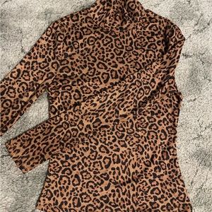 Black and brown cheetah print, tight fitting, long sleeve, turtle neck.